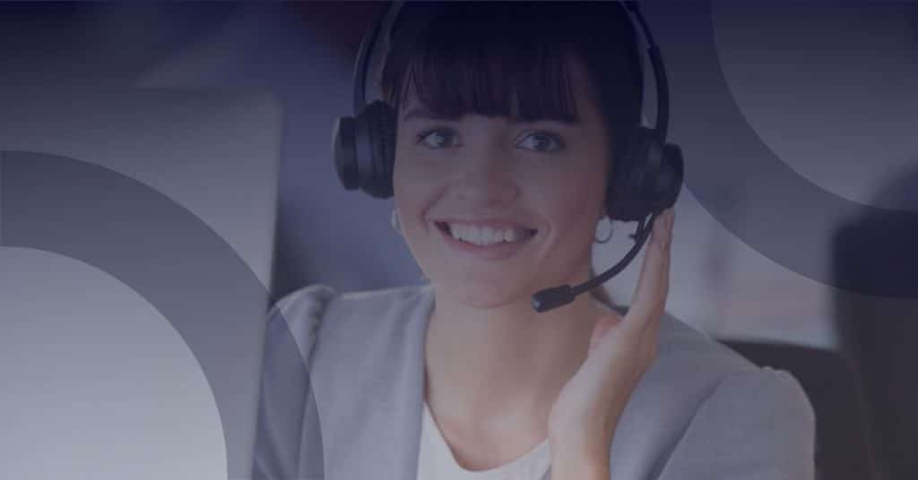 Smiling woman wearing a headset, providing digital support for not-for-profit organizations, emphasizing managed IT services and online communication.