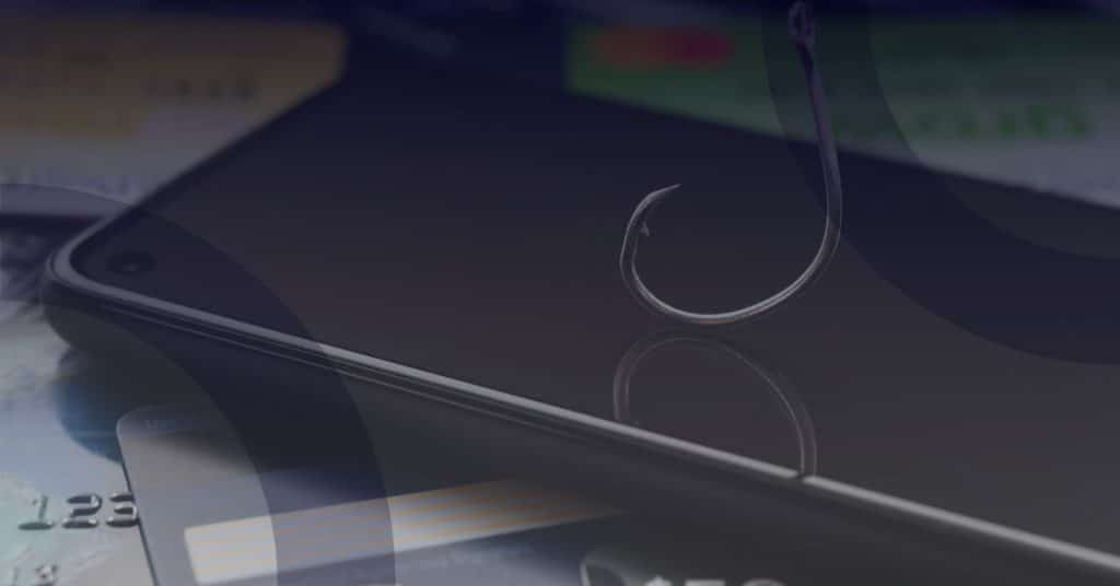 Smartphone with a fishing hook symbolizing phishing scams, surrounded by credit cards, illustrating the vulnerability of not-for-profits to cybercrime.