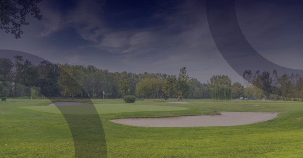 Golf course landscape with sand traps and lush greenery, illustrating the importance of technology in enhancing sports club experiences.