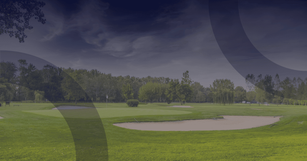 Golf course landscape featuring lush greens, sand traps, and trees, highlighting the importance of IT partnerships for golf clubs.