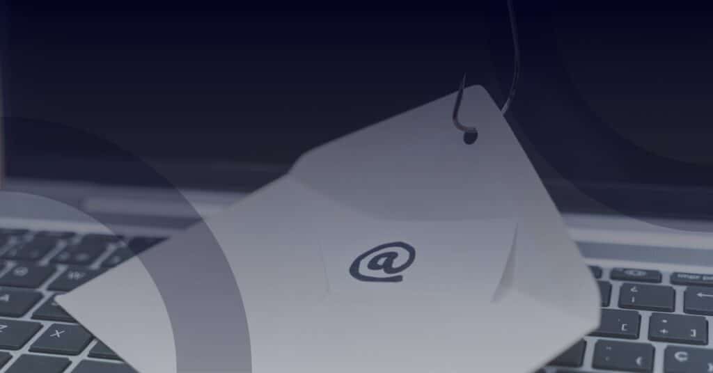 Laptop keyboard with a tag featuring an '@' symbol, representing cybersecurity myths and email security.