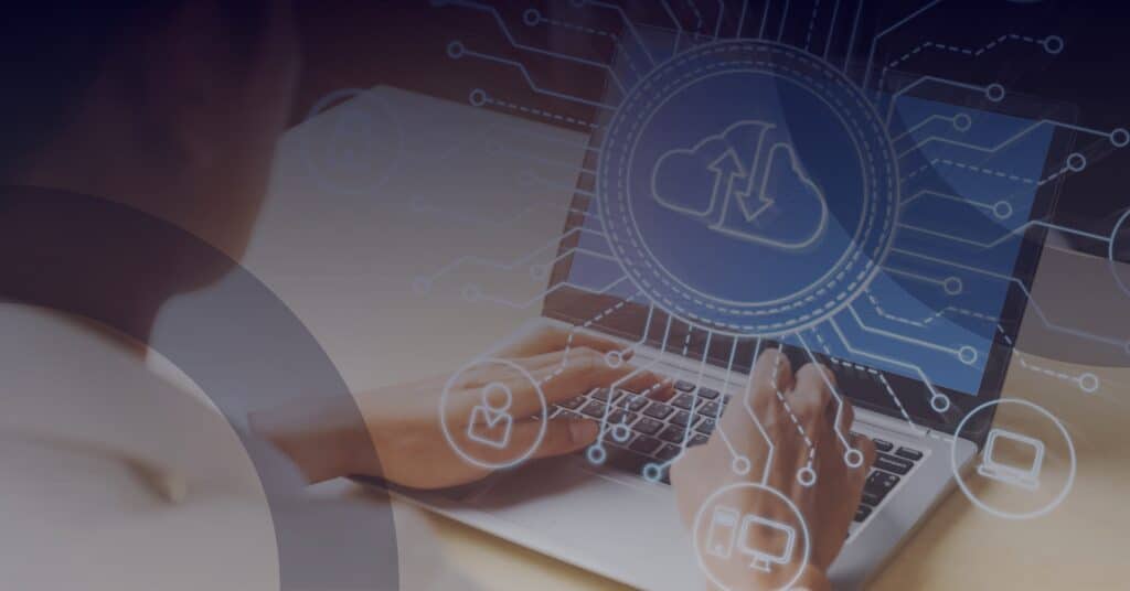 Person using a laptop with cloud computing graphics, symbolizing Reliable Networks' G-Cloud 14 services for IT management and digital transformation.
