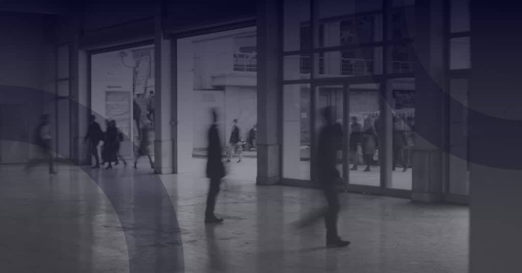 People walking through a modern public sector building, symbolizing digital transformation and the impact of G-Cloud 14 on cloud technology adoption.