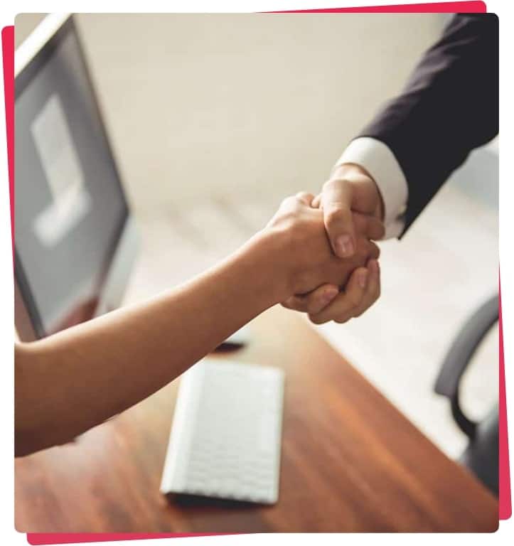 Handshake between business professionals in an office setting, symbolizing collaboration and partnership in IT services for financial firms.